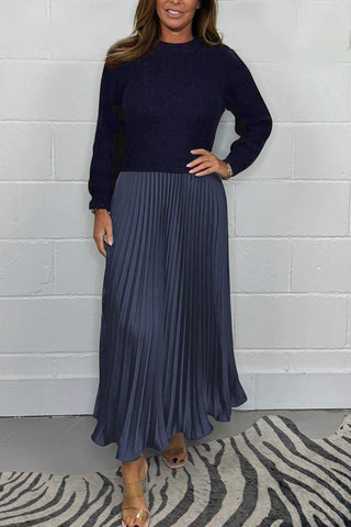 Urbana Plissierter Rock in stilvollem Marineblau, kombiniert mit einem passenden, schlichten Strickpullover. Das elegante, fließende Design des Rocks sorgt für einen zeitlosen Look, ideal für besondere Anlässe oder den modernen Alltagsstil.